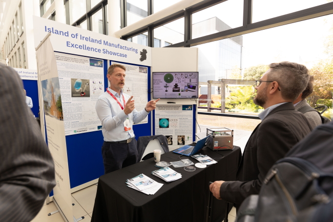 Two people talking at an exhibition stand